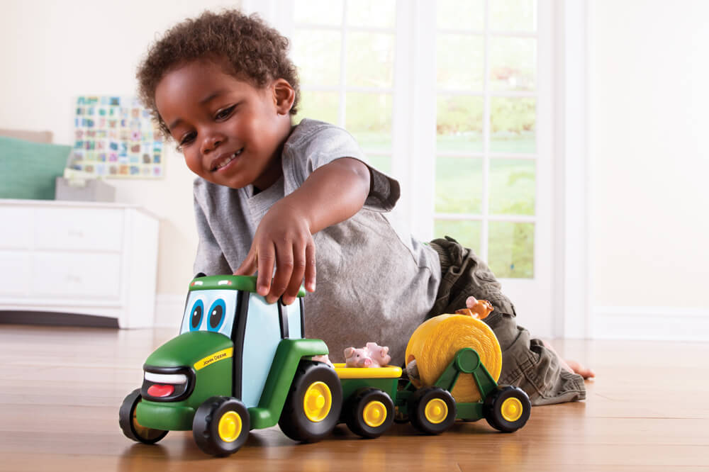 Image of child playing with John Deere
