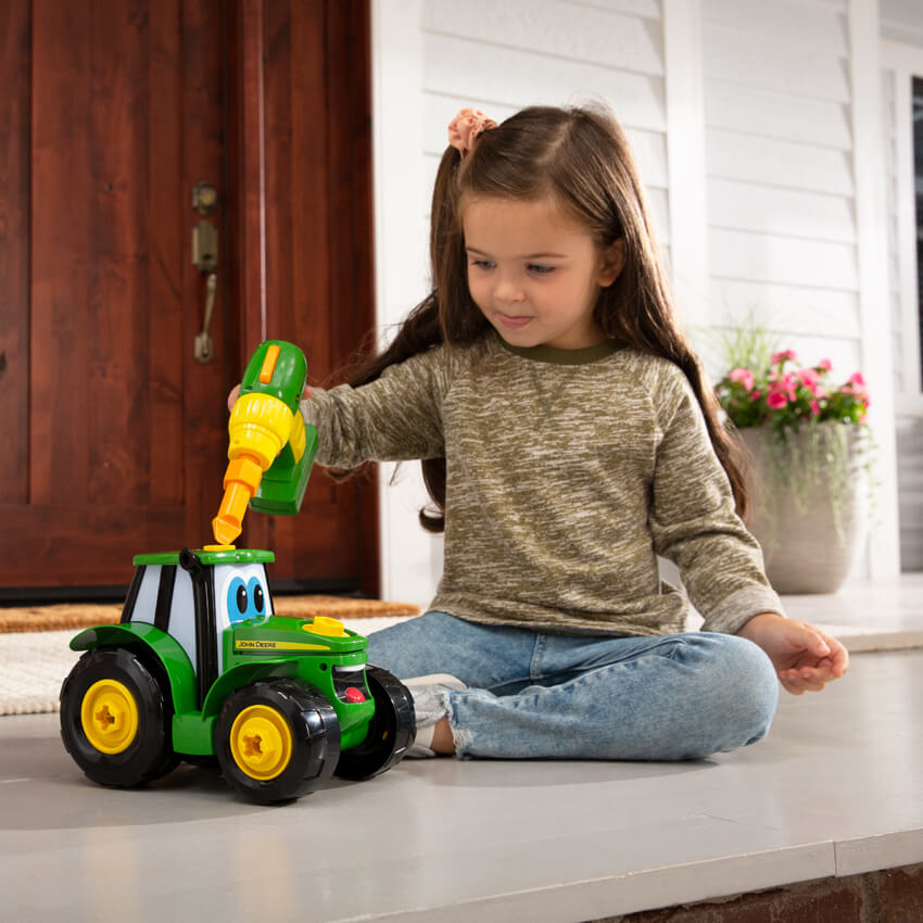 Child playing with John Deere product